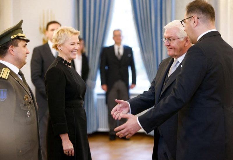 Oleksii Makeiev gestures next to his wife Olena Makeieva and German President Frank-Walter Steinmeier, on the day he receives his accreditation as Ukraine's Ambassador to Germany, at Bellevue Castle, in Berlin, Germany October 24, 2022. REUTERS/Michele Tantussi