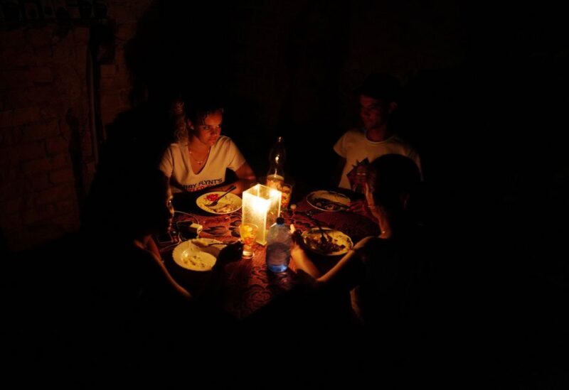 A family has dinner during a blackout in the aftermath of Hurricane Ian in Havana, Cuba, September 28, 2022. REUTERS