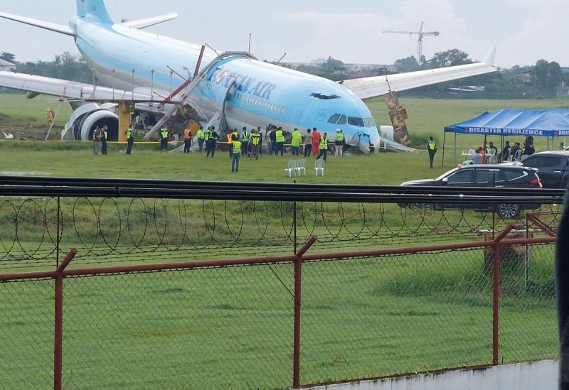 Response crews gather around a Korean Air Airbus A330 widebody flying from Seoul to Cebu, which tried to land twice in poor weather before it overran the runway on the third attempt on Sunday, in Lapu-Lapu City, Cebu, Philippines October 24, 2022 - Reuters