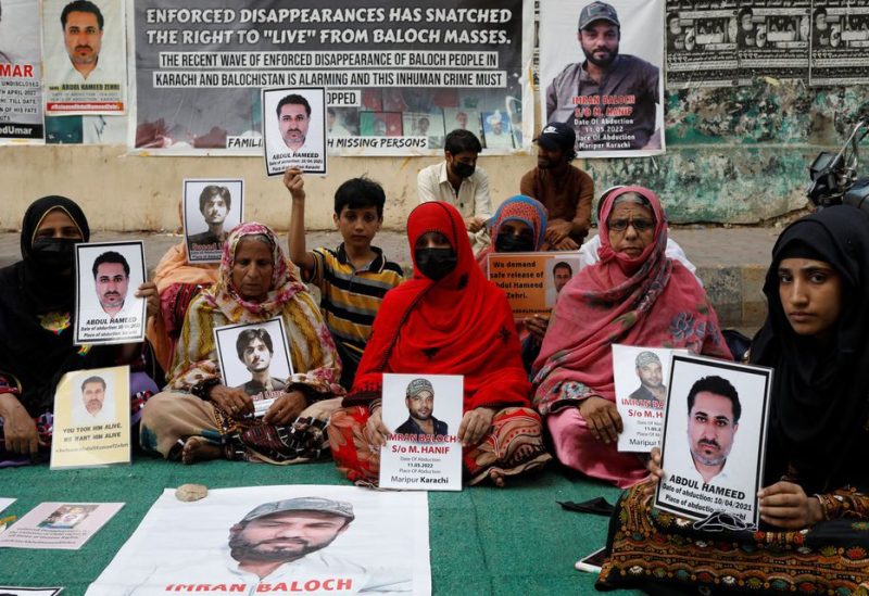 Family members of missing or disappeared persons of the Baloch people hold portraits of their loved ones during a protest in Karachi, Pakistan July 1, 2022. REUTERS