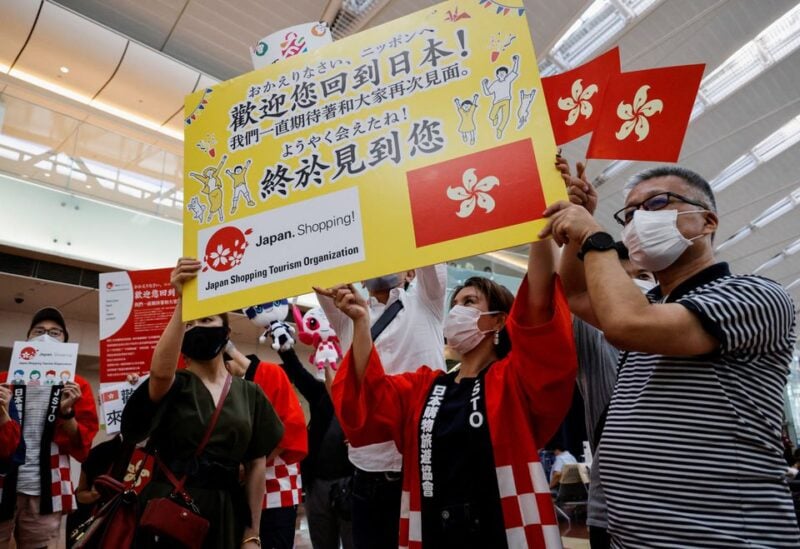 Members from Japan's shopping and tourism companies hold a placard reading 'Welcome back to Japan! We finally met you!' after two years of coronavirus disease restrictions, in Tokyo, Japan, June 26, 2022 REUTERS