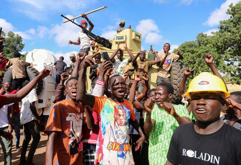 Supporters of Burkina Faso's self-declared new leader Ibrahim Traore demonstrate as they stand on soldiers armoured vehicles in Ouagadougou, Burkina Faso October 2, 2022. REUTERS/Vincent Bado TPX IMAGES OF THE DAY