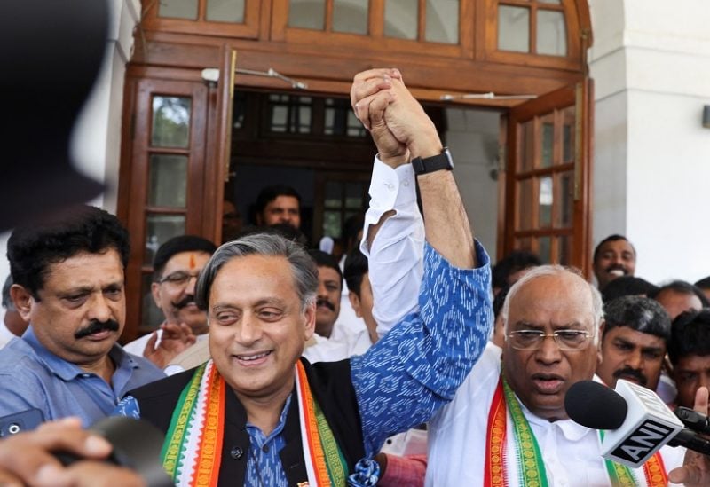 Mallikarjun Kharge, newly elected president of the Congress party, India's main opposition party, raises his hand with party colleague Shashi Tharoor at Kharge’s residence in New Delhi, India, October 19, 2022. REUTERS/Altaf Hussain