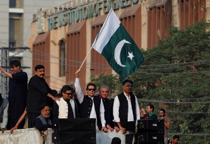 Pakistan's former prime minister Imran Khan waves the national flag during what they call 'a true freedom march', to pressure the government to announce new elections, in Lahore, Pakistan October 28, 2022. REUTERS/Akhtar Soomro