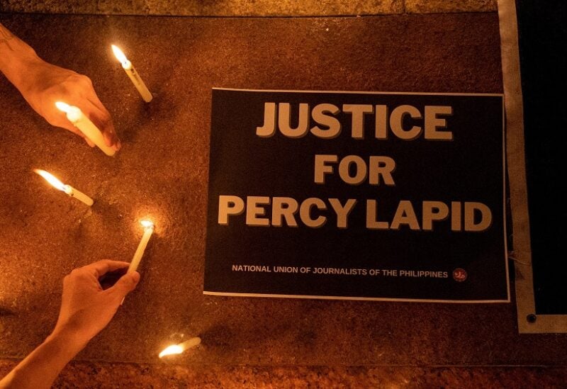 Journalists and activists light candles for killed Filipino radio journalist Percival Mabasa during an indignation rally, in Quezon City, Philippines, October 4, 2022. Mabasa, 63, was killed by two assailants at the gate of a residential compound in the Las Pinas area of Manila on October 3, 2022. REUTERS/Eloisa Lopez TPX IMAGES OF THE DAY