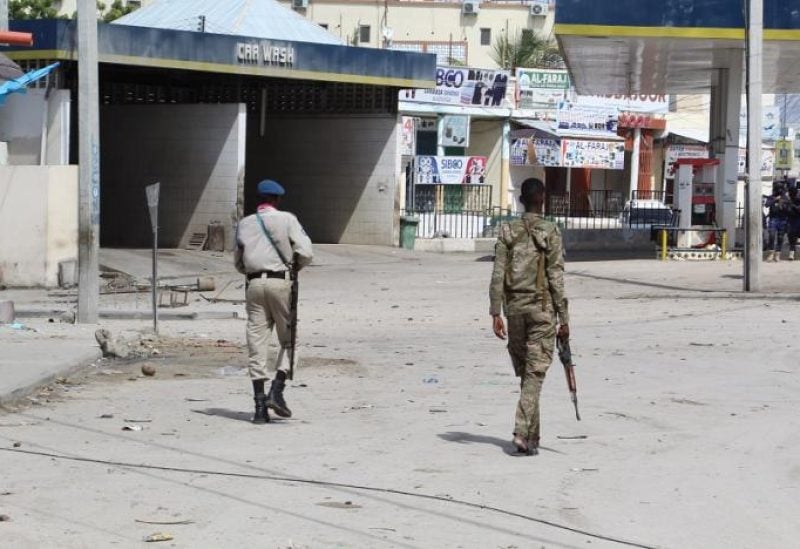 Somali security officials gather at the scene of an attack, outside the Hayat Hotel in Mogadishu, Somalia, 20 August 2022.