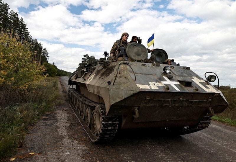 FILE PHOTO: Ukrainians ride an armoured vehicle, amid Russia's attack on Ukraine, in Donesk region, Ukraine, October 3 2022. REUTERS/Zohra Bensemra/File Photo