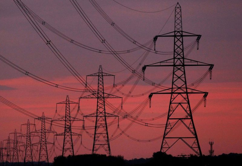 The sun rises behind electricity pylons near Chester, northern England October 24, 2011. REUTERS/Phil Noble