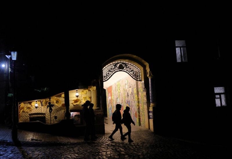 People walk on a dark street, as Russia's attack on Ukraine continues, in the old town of Kyiv, Ukraine November 6, 2022. REUTERS/Murad Sezer