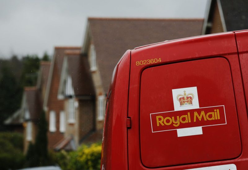 A Royal Mail postal van is parked outside homes in Maybury near Woking in southern England March 25, 2014. REUTERS/Luke MacGregor