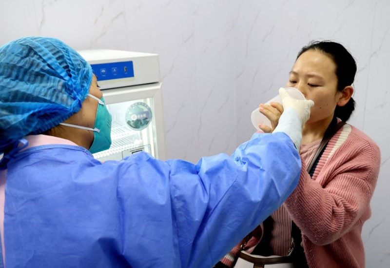 A resident takes an inhaled COVID-19 vaccine produced by Chinese pharmaceutical firm CanSino Biologics, at a community health service centre in Lianyungang, Jiangsu province, China November 3, 2022. China Daily via REUTERS