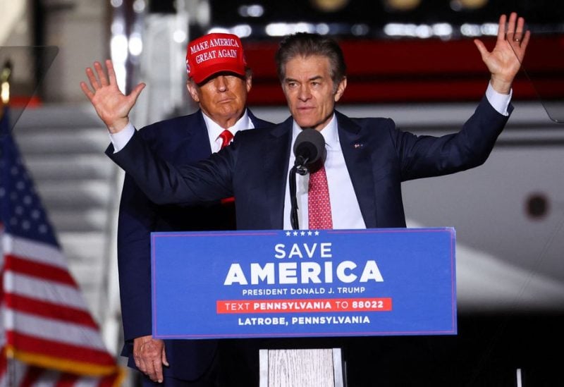 Former U.S. President Donald Trump looks on as Pennsylvania Republican U.S. Senate candidate Dr. Mehmet Oz speaks at a pre-election rally to support Republican candidates in Latrobe, Pennsylvania, U.S., November 5, 2022. REUTERS/Mike Segar