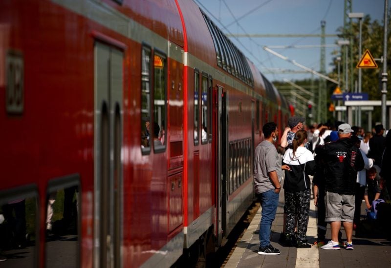 Rail passengers wait outside a regional train to Rostock that stopped due to overcrowding after a special nine-euro ticket that includes the usage of local buses and trains nationwide for a month, was released by Deutsche Bahn and other transport operators in Kratzeburg, Germany, June 4, 2022. REUTERS/Lisi Niesner/File Photo