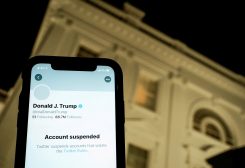 A photo illustration shows the suspended Twitter account of U.S. President Donald Trump on a smartphone and a lit window in the White House residence in Washington, U.S., January 8, 2021. REUTERS/Joshua Roberts/Illustration/File Photo