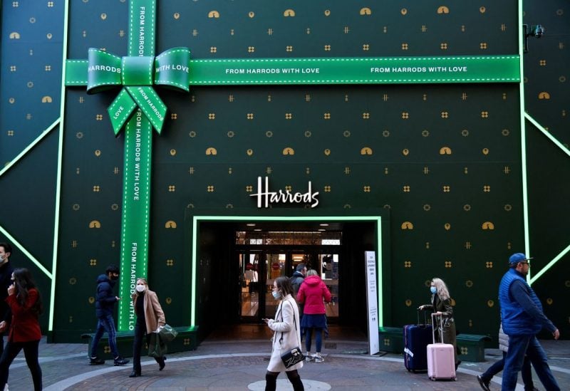 People enter and depart the food hall of Harrods store during the coronavirus pandemic, in London, Britain, December 20, 2020. Harrods is owned by the Qatar Investment Authority. REUTERS/Toby Melville/File Photo