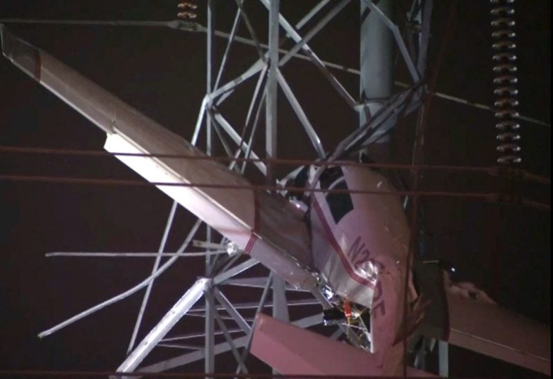 A small airplane hangs about 100 feet (33 metres) above the ground after crashing into an electricity tower in Gaithersburg, Maryland, U.S. November 27, 2022 in a still image from video. ABC affiliate WJLA via REUTERS