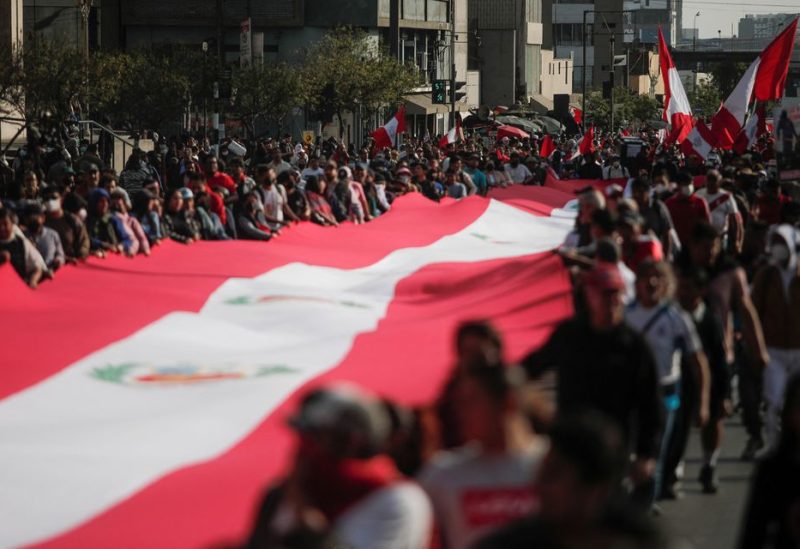 People carry a Peruvian flag, during a protest against the government of Peru's President Pedro Castillo, in Lima, Peru November 5, 2022. REUTERS/Sebastian Castaneda