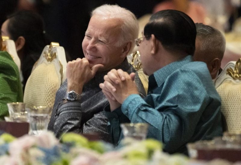 FILE - U.S. President Joe Biden, left, and Cambodian Prime Minister Hun Sen share a moment as they watch a cultural dance performance at the Association of Southeast Asian Nations (ASEAN) gala dinner, Saturday, Nov. 12, 2022, in Phnom Penh, Cambodia. Hun Sen said Tuesday, Nov. 15, 2022, he has tested positive for COVID-19 at the Group of 20 meetings in Bali, just days after hosting many world leaders, including President Joe Biden, for a summit in Phnom Penh. (AP Photo/Alex Brandon, File)