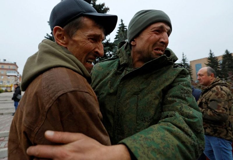 A serviceman hugs his brother after being released along with other military personnel from Russian-controlled parts of Donetsk REUTERS