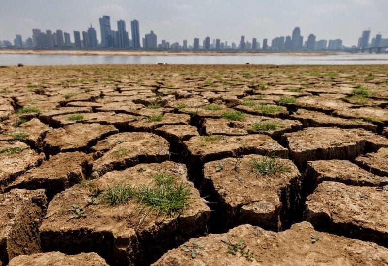 Cracks run through the partially dried-up river bed of the Gan River, a tributary to Poyang Lake during a regional drought in Nanchang, Jiangxi province, China, August 28, 2022. REUTERS/Thomas Peter/File Photo