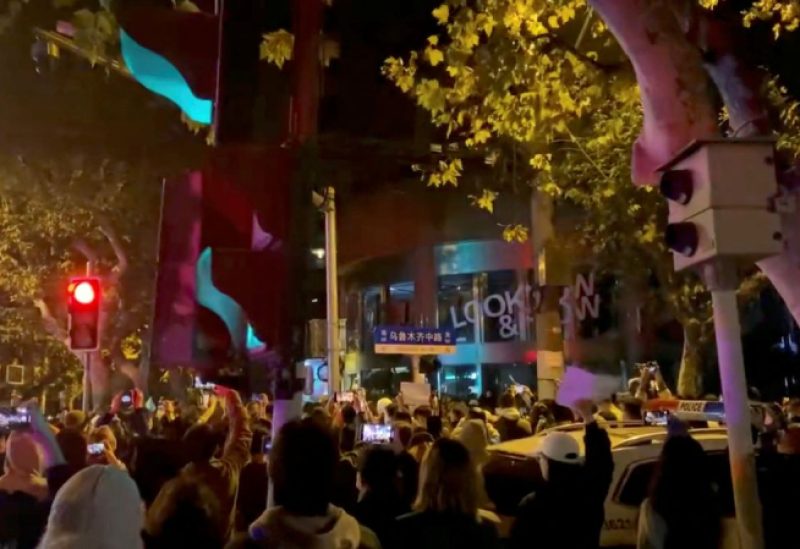 People protest against coronavirus disease (COVID-19) curbs, at the site of a candlelight vigil for victims of the Urumqi fire, in Shanghai, China, in this screengrab from a video realeased on November 27, 2022. Video obtained by Reuters/via REUTERS
