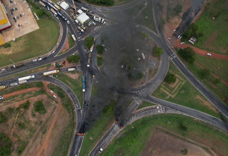 An aerial view shows demonstrators burning tires to block federal roads during a protest the day after the Brazilian presidential election run-off, in Varzea Grande in Mato Grosso state, Brazil, October 31, 2022. REUTERS