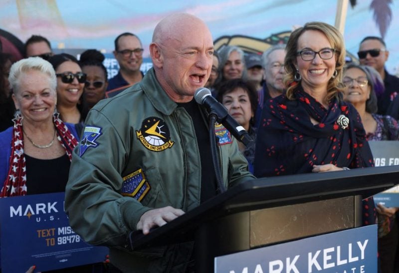 U.S. Senator Mark Kelly (D-AZ) and his wife Gabby Giffords, a former member of the United States House of Representatives, declares victory in his re-election campaign against Republican challenger Blake Masters the U.S. midterm elections in Phoenix, Arizona, U.S., November 12, 2022. REUTERS/Jim Urquhart