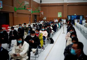People sit at a vaccination site after receiving a dose of a coronavirus disease (COVID-19) vaccine, during a government-organised visit, following the coronavirus disease (COVID-19) outbreak, in Shanghai, China January 19, 2021. REUTERS/Aly Song
