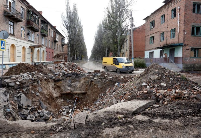 A van drives past a crater in the road caused by a missile strike, as Russia's invasion of Ukraine continues, in the eastern Donbas region of Bakhmut, Ukraine, November 1, 2022. REUTERS