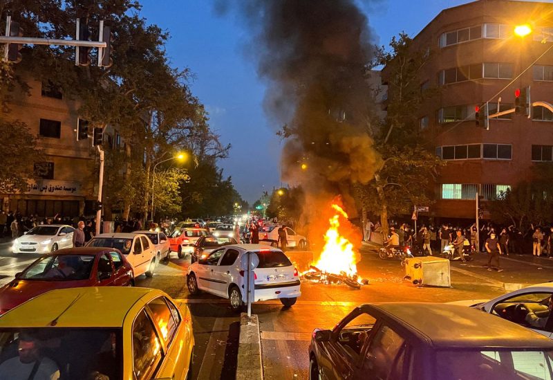 A police motorcycle burns during a protest over the death of Mahsa Amini, a woman who died after being arrested by the Islamic republic's "morality police", in Tehran, Iran September 19, 2022. WANA (West Asia News Agency) via REUTERS/File Photo