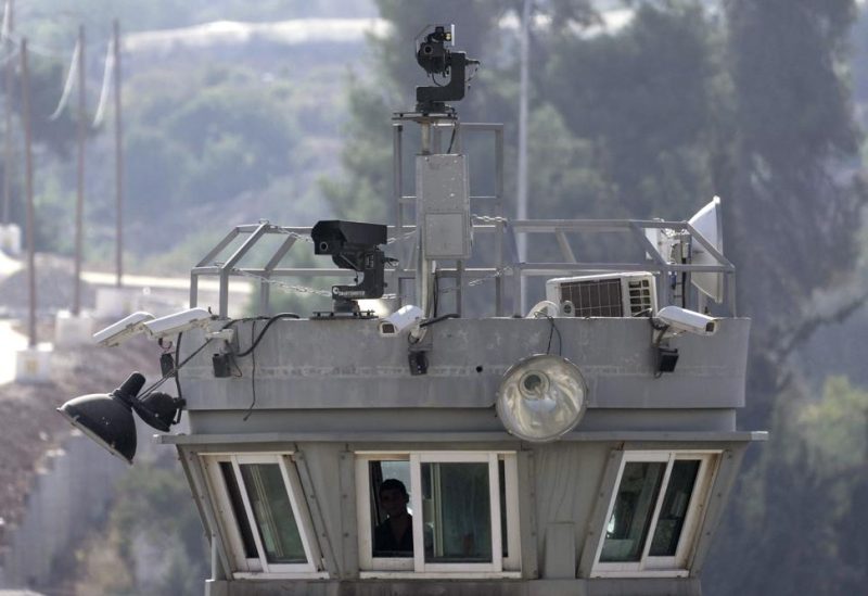 Two robotic guns sit atop a guard tower bristling with surveillance cameras pointed at the Aroub refugee camp in the West Bank, Thursday, Oct. 6, 2022. Israel has installed robotic weapons that can fire tear gas, stun grenades and sponge-tipped bullets at Palestinian protesters. The robots, perched over a crowded Palestinian refugee camp and in a flash point West Bank city, use artificial intelligence to track targets. (AP Photo/Mahmoud Illean)