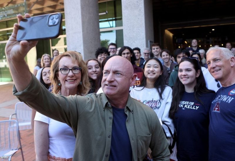U.S. Senator Mark Kelly and his wife Gabby Giffords take a selfie at a campaign event ahead of the November 8, 2022 U.S. midterm elections in Tucson, Arizona, U.S., November 6, 2022. REUTERS/Jim Urquhart