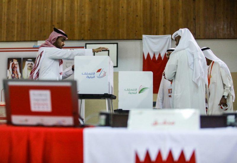 Bahraini poll clerks prepare ballot boxes at a polling station on the island of Muharraq, north of the capital Manama, during parliamentary elections, on November 12, 2022. (Photo by AFP)