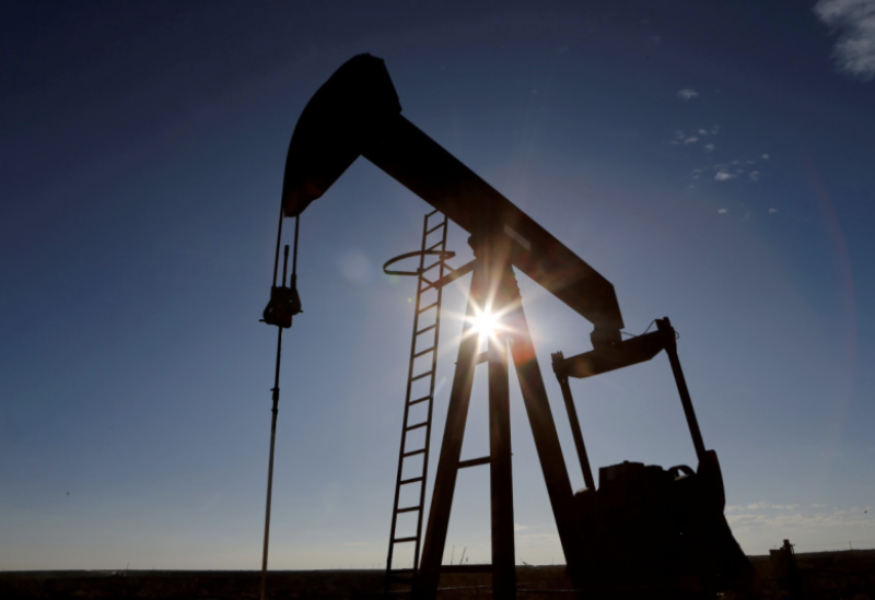 The sun is seen behind a crude oil pump jack in the Permian Basin in Loving County, Texas, on November 22, 2019.