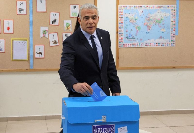 Israeli Prime Minister Yair Lapid casts his vote at a polling station in Israel's coastal city of Tel Aviv in the coutnry's fifth election in four years on November 1, 2022. - Lapid urged the electorate to cast their ballot after voting in an election that might see veteran leader Benjamin Netanyahu making a comeback alongside far-right allies. Photo by JACK GUEZ/Pool via REUTERS