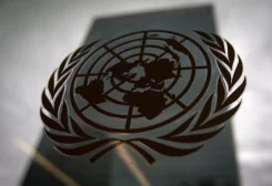 United Nations headquarters building is pictured though a window with the UN logo in the foreground in the Manhattan borough of New York August 15, 2014. REUTERS