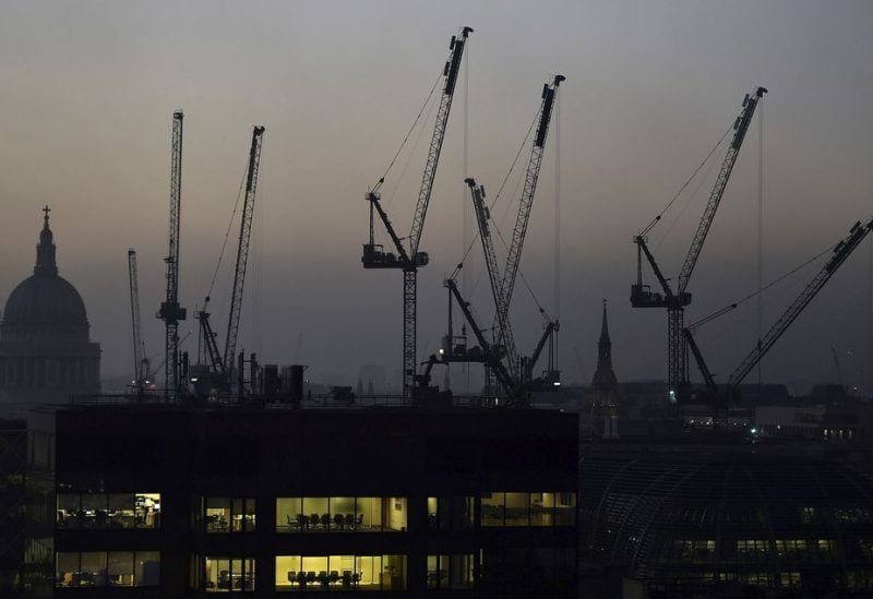 Offices are seen at dusk as St. Paul's cathedral and construction cranes are seen on the skyline in the City of London, Britain November 2, 2015. REUTERS