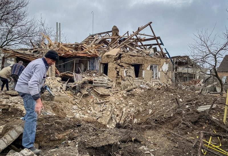 Local residents inspect a crater left by a Russian military strike, as their attack in Ukraine continues, in the village of Komyshuvakha, Zaporizhzhia region, Ukraine, November 21, 2022. REUTERS/Sergiy Chalyi