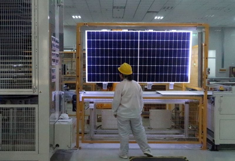 A worker conducts quality-check of a solar module product at a factory of a monocrystalline silicon solar equipment manufacturer LONGi Green Technology Co, in Xian, Shaanxi province, China December 10, 2019. REUTERS