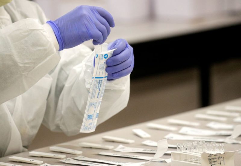 A health care worker prepares coronavirus tests in a lab at a COVID drive-thru testing center at Bergen Community College, as the global outbreak of the coronavirus disease (COVID-19) continues, in Paramus, New Jersey, U.S., December 3, 2020. REUTERS