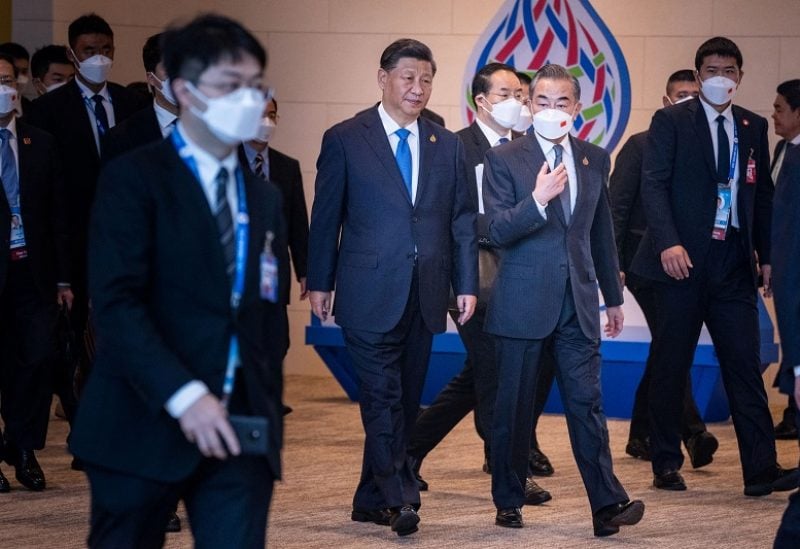 Chinese President Xi Jinping, along with Chinese Foreign Minister Wang Yi, arrives at Queen Sirikit National Convention Center in Bangkok, Thailand, on Saturday, Nov. 19, 2022 for the Asia-Pacific Economic Cooperation (APEC) summit. Haiyun Jiang/Pool via REUTERS