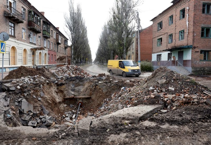 A van drives past a crater in the road caused by a missile strike, as Russia's invasion of Ukraine continues, in the eastern Donbas region of Bakhmut, Ukraine, November 1, 2022. REUTERS/Clodagh Kilcoyne