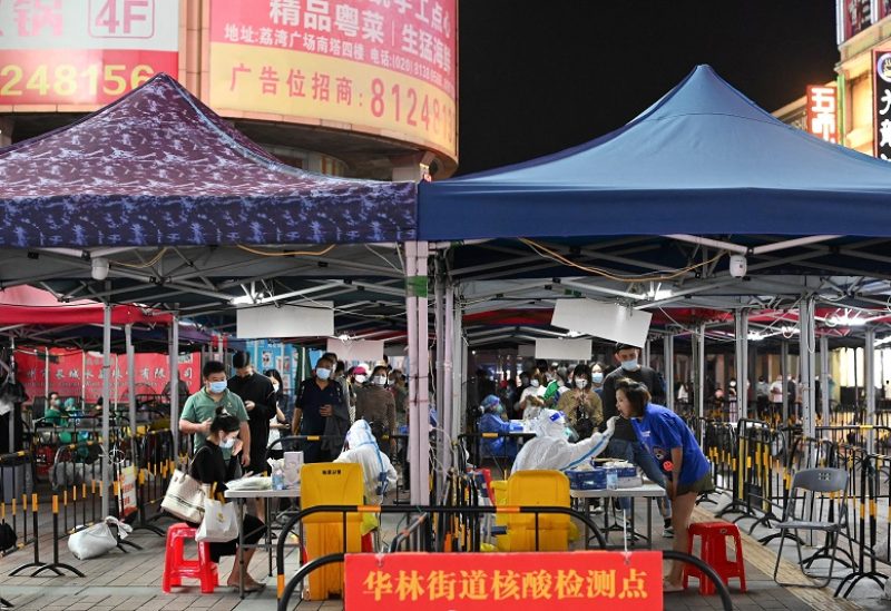 People line up to take nucleic acid test for the coronavirus disease (COVID-19) following the outbreak, at a makeshift testing site in Guangzhou, Guangdong province, China November 9, 2022. cnsphoto via REUTERS ATTENTION EDITORS - THIS IMAGE WAS PROVIDED BY A THIRD PARTY. CHINA OUT.