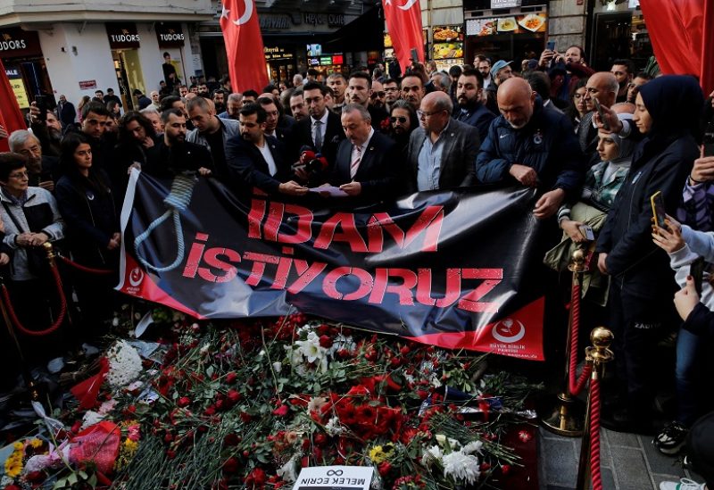 Members of Grand Unity Party (BBP) Party lay flowers and open a banner that reads "we want the death penalty" as they pay tribute to the victims of a Sunday's blast that took place on Istiklal Avenue, a popular spot for shoppers and tourists, in Istanbul, Turkey, November 15, 2022. REUTERS/Dilara Senkaya