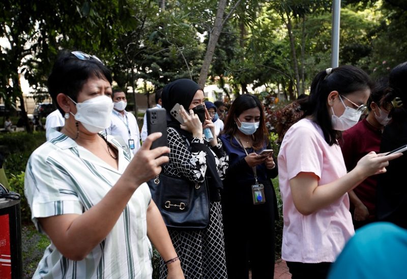 People gather as they are evacuated outside a building following an earthquake in Jakarta, Indonesia, November 21, 2022. REUTERS/Ajeng Dinar Ulfiana