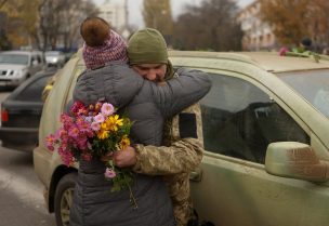 A local resident hugs a Ukrainian serviceman after Russia's retreat from Kherson, in central Kherson, Ukraine November 13, 2022. REUTERS/Valentyn Ogirenko TPX IMAGES OF THE DAY