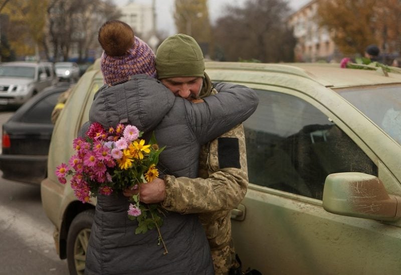 A local resident hugs a Ukrainian serviceman after Russia's retreat from Kherson, in central Kherson, Ukraine November 13, 2022. REUTERS/Valentyn Ogirenko TPX IMAGES OF THE DAY