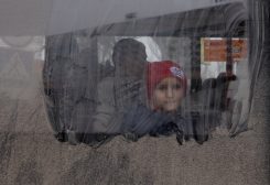 A boy looks out from an evacuation bus, after Russia's military retreat from Kherson, at the central bus station in Kherson, Ukraine November 24, 2022. REUTERS/Murad Sezer TPX IMAGES OF THE DAY