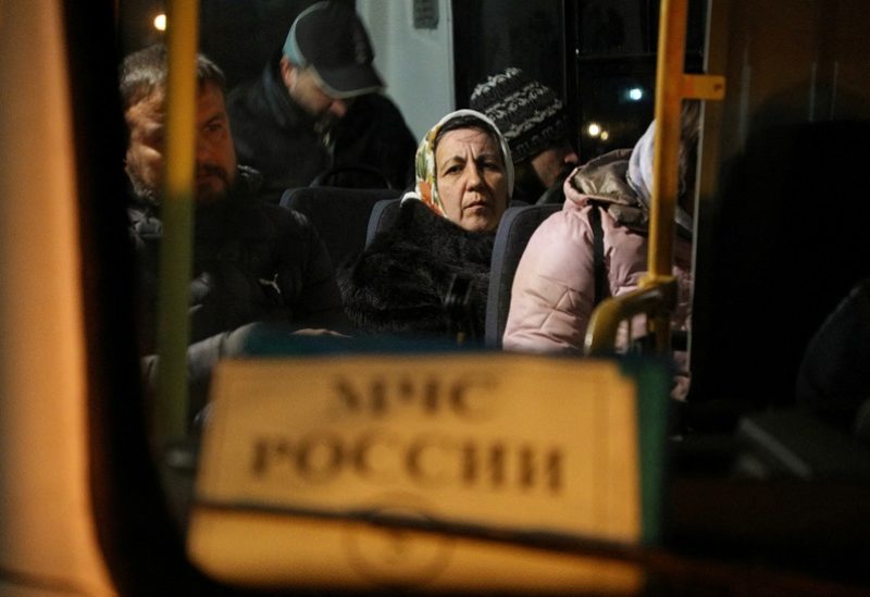 Civilians evacuated from the Russian-controlled part of Kherson region of Ukraine sit inside a bus as they arrive at a local railway station in the town of Dzhankoi, Crimea November 10, 2022. REUTERS/Alexey Pavlishak TPX IMAGES OF THE DAY