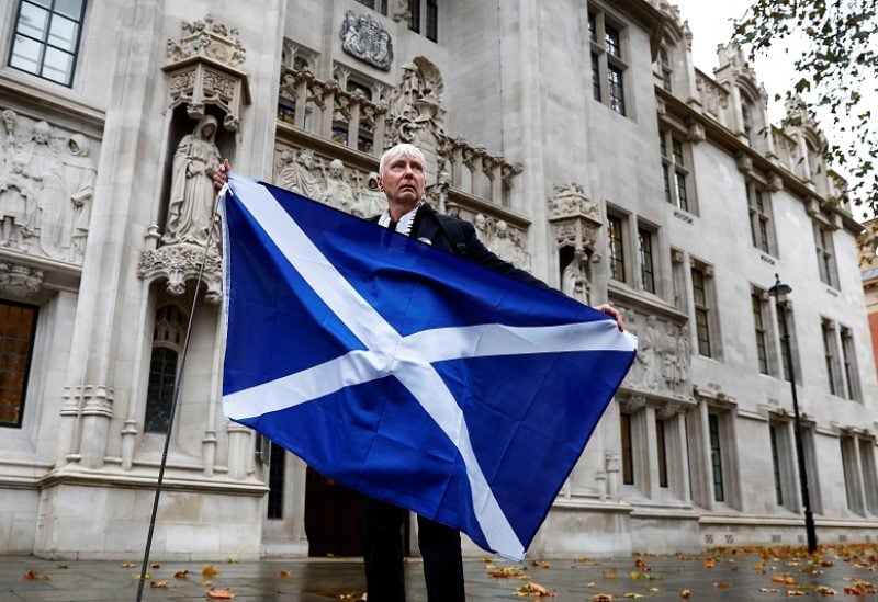 A pro-Scottish independence campaigner poses with a Scottish flag outside the United Kingdom Supreme Court in a case to decide whether the Scottish government can hold a second referendum on independence next year without approval from the British parliament, in London, Britain November 23, 2022. REUTERS/Peter Nicholls